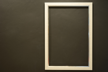Blank white picture frame on Dark green wall texture backgroundの写真素材