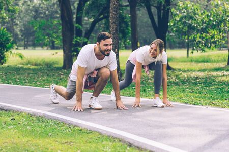 Lover couple smiling and running in the Parkの写真素材
