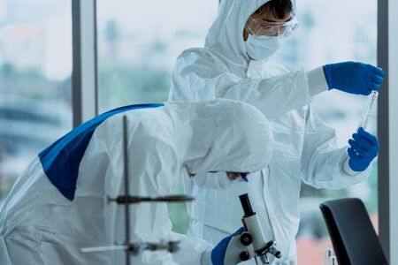Lab Technician in Personal protective equipment  PPE suit Vaccines testing of Virus