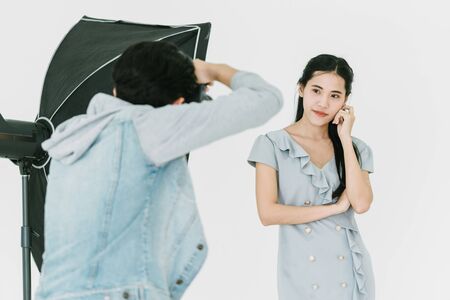 Asian Photographer shooting with female model in Studio with studio strobeの写真素材