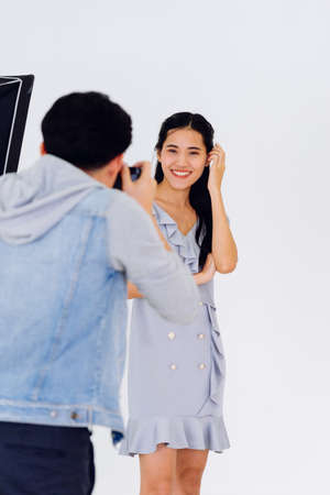 Asian Photographer shooting with female model in Studio with studio strobeの写真素材