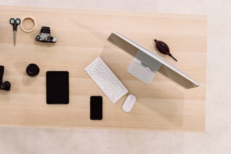 The computer is on the wooden table Decorated in a minimal style view from topの写真素材