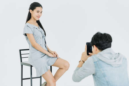 Asian Photographer shooting with female model in Studio with studio strobeの写真素材