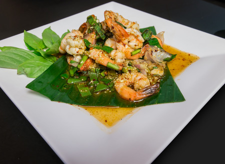 Thai shrimp spicy salad on white plateの写真素材