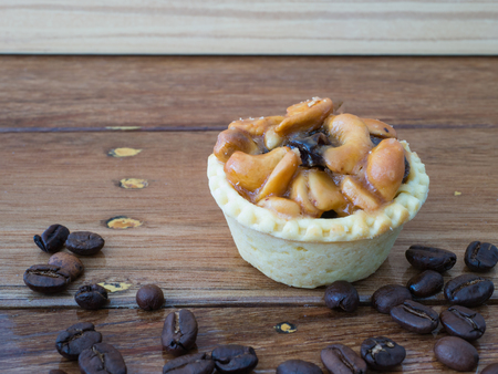 coffee bean and cashew nuts tart on wood backgroundの写真素材