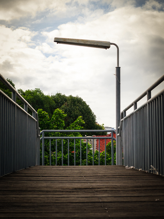 Wooden pathway with Street light and guard rail.の写真素材