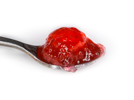Strawberry jam in silverspoon isolate on white backgroundの写真素材