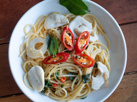 spicy stir spaghetti with chili, black pepper basil leaf and fish ballの写真素材