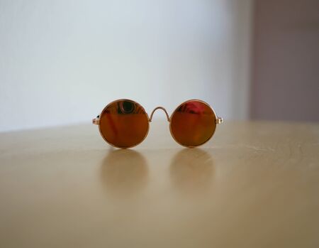 Mini sunglasses for small pet like cat or dog on wooden floorの写真素材