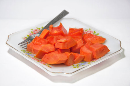 Papaya fruit in dish on white backgroundの写真素材