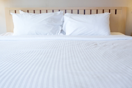 white bed and pillowsの写真素材