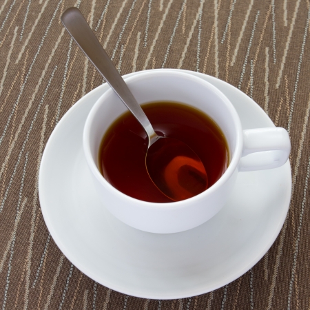 a white cup of hot teaの写真素材