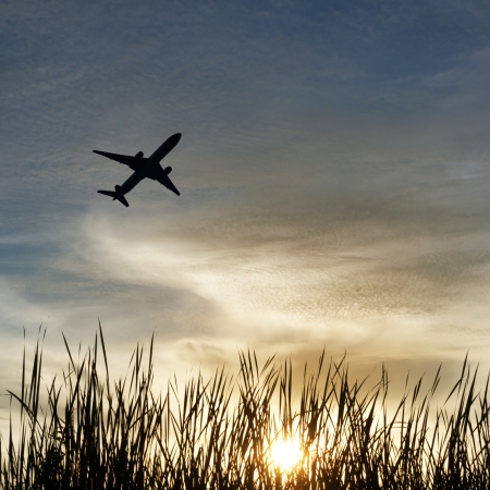 Silhouette of an airplane with sunset skyの写真素材
