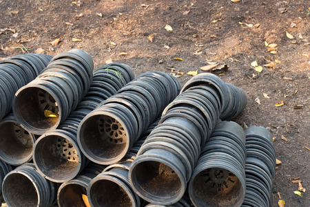 empty black gardening buckets on the groundの写真素材