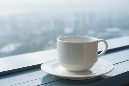 coffee cup near windowの写真素材