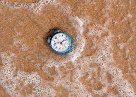 alarm clock on sand each