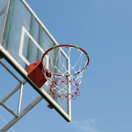 basketball hoop against blue sky backgroundの写真素材