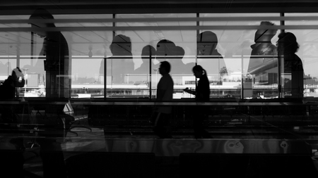 Silhouette of double exposure shot, people busy in the airportの写真素材