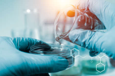 Science and medicine concept.scientist Beaker pouring a sample into a test tube and science...