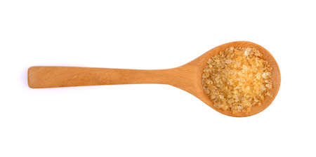 Brown sugar in a wooden spoon isolated on whiteの写真素材