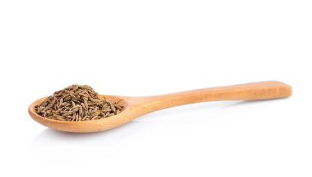 dried cumin seed or caraway in wooden spoon isolated on white backgroundの写真素材