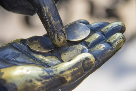 hand with coins at the dummyの写真素材