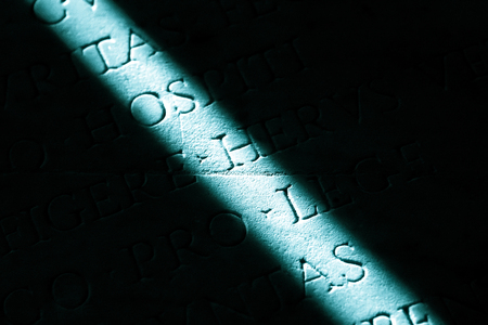 Narrow beam of light on a stone with inscriptionsの写真素材