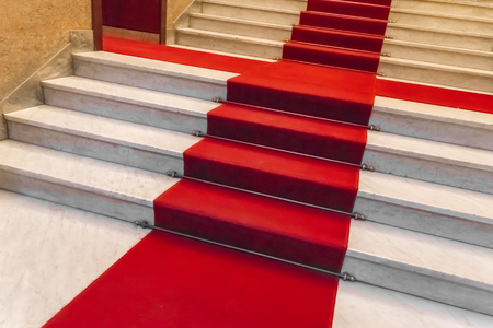 White marble staircase with a red carpetの写真素材