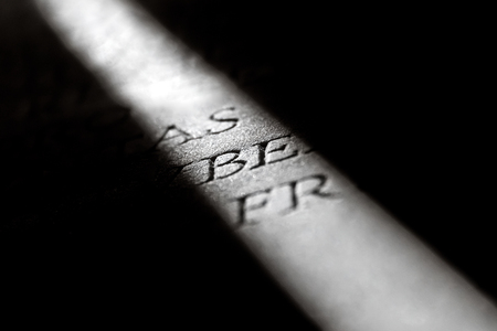 Narrow beam of light on a stone with inscriptionsの写真素材