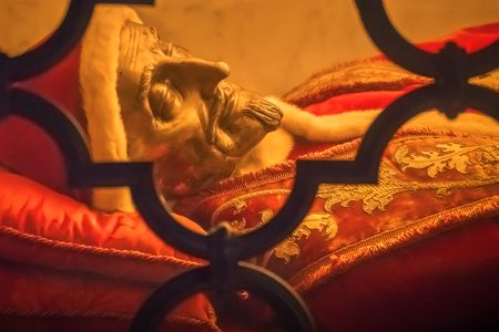 Sculpture of the deceased person behind barsの写真素材