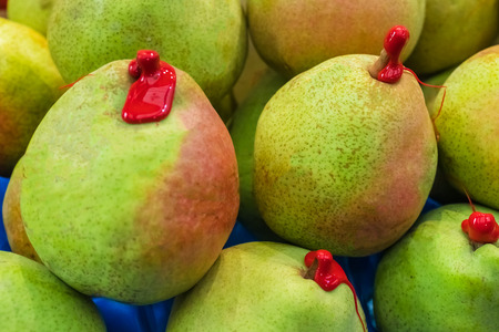 Green pears with red sealing wax, backgroundの写真素材