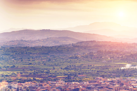 Scenic view of the city and the mountains on a sunny dayの写真素材