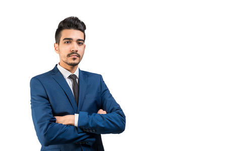 Young attractive man in a blue suit standing with crossed arms on a white background. Isolatedの写真素材