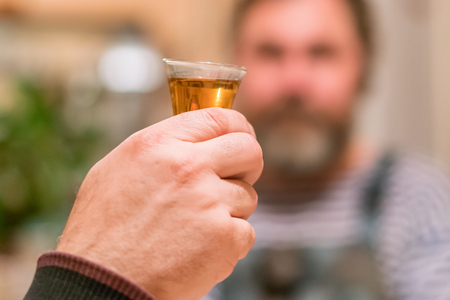 Hand with glass of alcohol. Toastの写真素材