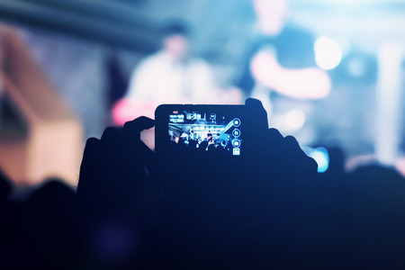 Man removes on the smartphone show in a nightclub