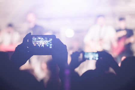 Man removes on the smartphone show in a nightclub
