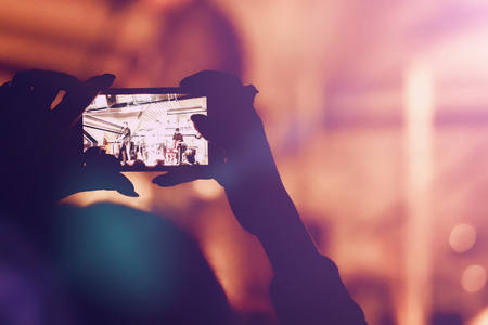 Man removes on the smartphone show in a nightclubの写真素材