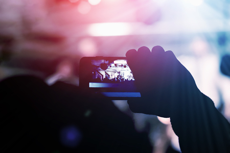 Man removes on the smartphone show in a nightclubの写真素材