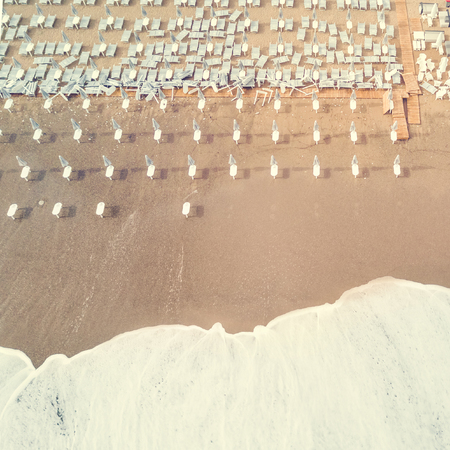 Sandy beach with sun beds, view from aboveの写真素材