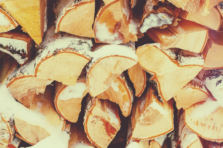 Firewood covered with snow, backgroundの写真素材