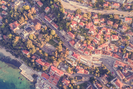 Top view of the resort town with red roofs and seaの写真素材
