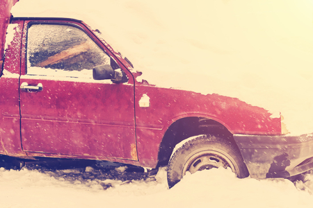 Parked red car covered with snow. Tonedの写真素材