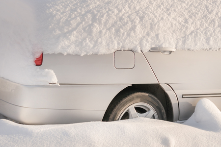 Parked car covered with snowの写真素材