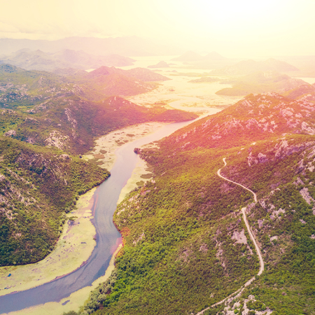 Top view of a river covered with green algae in the mountains on a sunny dayの写真素材
