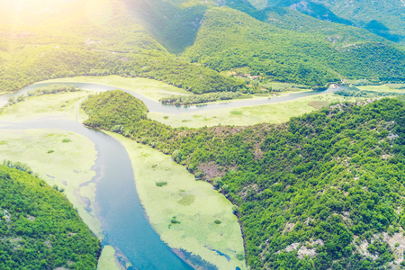Top view of a river covered with green algae in the mountainsの写真素材