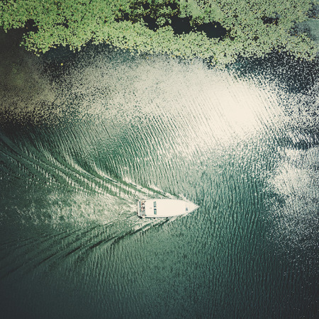 Boat floating on the water covered with green algaeの写真素材
