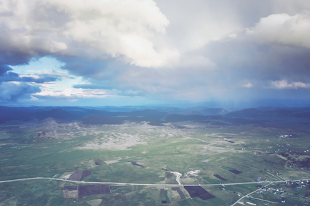Top view of a mountain valley and asphalt roadの写真素材