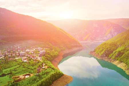 Beautiful view of the resort town in the mountains by the lake at sunset, top viewの写真素材