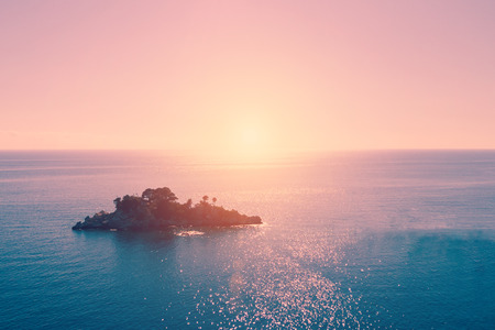 Top view of a beautiful island in the sea at sunsetの写真素材
