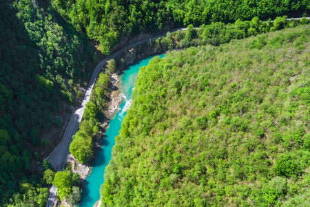 Top view of the river in the mountains surrounded by a green forestの写真素材